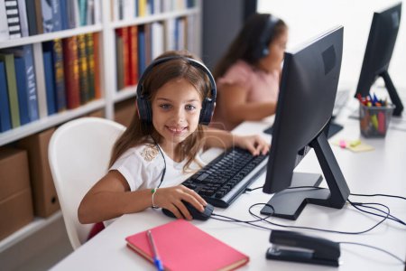 Photo for Two kids students using computer studying at classroom - Royalty Free Image