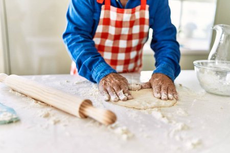 Photo for Senior man cooking pizza dough with hands at kitchen - Royalty Free Image