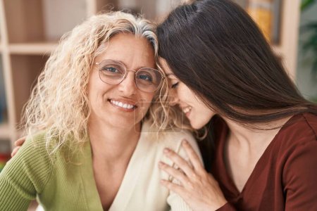 Photo for Two women mother and daughter hugging each other at home - Royalty Free Image