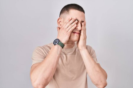 Photo for Young man standing over isolated background rubbing eyes for fatigue and headache, sleepy and tired expression. vision problem - Royalty Free Image