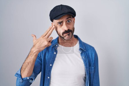 Photo for Hispanic man with beard standing over isolated background shooting and killing oneself pointing hand and fingers to head like gun, suicide gesture. - Royalty Free Image