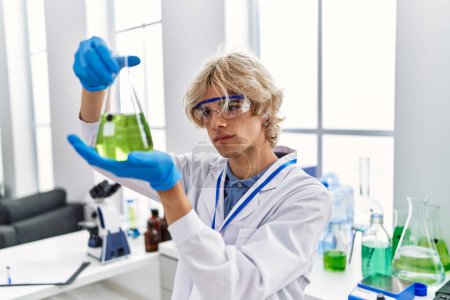Photo for Young blond man scientist holding test tube at laboratory - Royalty Free Image