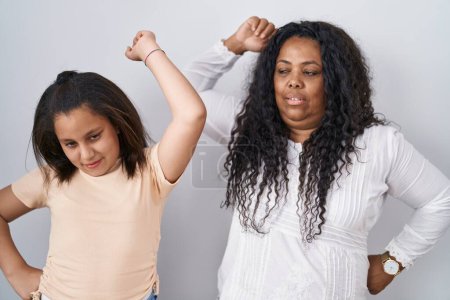 Photo for Mother and young daughter standing over white background stretching back, tired and relaxed, sleepy and yawning for early morning - Royalty Free Image