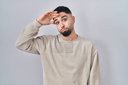 Photo for Young handsome man standing over isolated background worried and stressed about a problem with hand on forehead, nervous and anxious for crisis - Royalty Free Image
