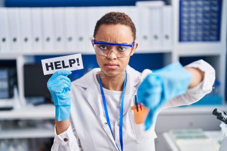 Photo for Beautiful african american woman working at scientist laboratory asking for help with angry face, negative sign showing dislike with thumbs down, rejection concept - Royalty Free Image