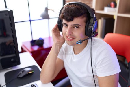 Photo for Non binary man streamer playing video game using computer at gaming room - Royalty Free Image