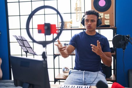 Téléchargez les photos : Young latin man artist having online music class at music studio - en image libre de droit