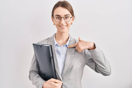Photo for Young caucasian woman wearing business clothes and glasses looking confident with smile on face, pointing oneself with fingers proud and happy. - Royalty Free Image
