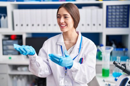 Photo for Young beautiful hispanic woman scientist smiling confident speaking at laboratory - Royalty Free Image