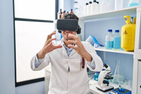 Photo for Young hispanic man scientist using virtual reality glasses at laboratory - Royalty Free Image