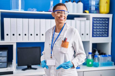 Photo for African american woman scientist smiling confident standing at laboratory - Royalty Free Image
