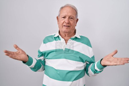 Photo for Senior man with grey hair standing over white background clueless and confused with open arms, no idea concept. - Royalty Free Image