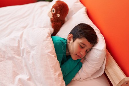 Photo for Adorable hispanic boy lying on bed sleeping at bedroom - Royalty Free Image