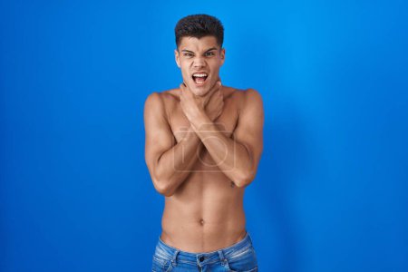 Photo for Young hispanic man standing shirtless over blue background shouting suffocate because painful strangle. health problem. asphyxiate and suicide concept. - Royalty Free Image