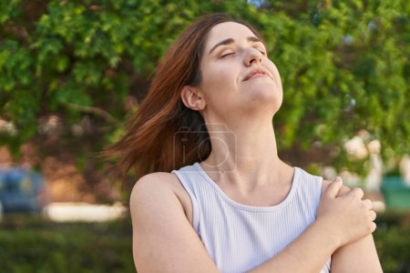 Photo for Young woman smiling confident breathing at park - Royalty Free Image