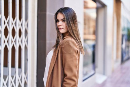 Photo for Young beautiful hispanic woman looking to the side with serious expression at street - Royalty Free Image