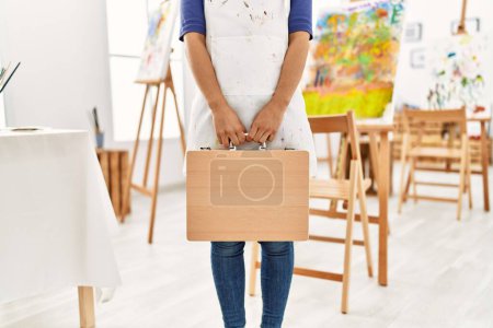 Photo for Young latin woman holding draw briefcase at art studio - Royalty Free Image