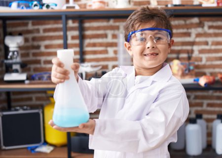 Photo for Adorable hispanic boy student smiling confident holding test tube at laboratory classroom - Royalty Free Image