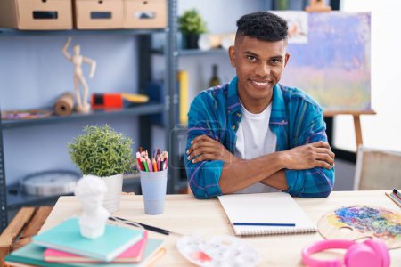 Photo for Young latin man artist smiling confident drawing on notebook at art studio - Royalty Free Image