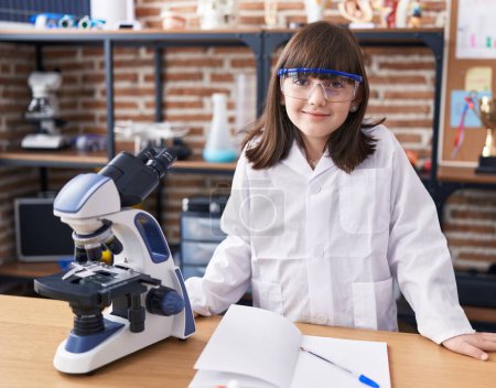 Photo for Adorable hispanic girl student smiling confident standing at laboratory classroom - Royalty Free Image