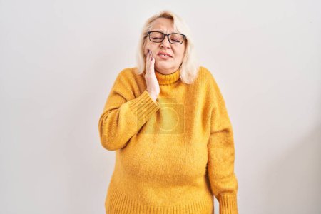 Photo for Middle age caucasian woman wearing glasses standing over background touching mouth with hand with painful expression because of toothache or dental illness on teeth. dentist - Royalty Free Image