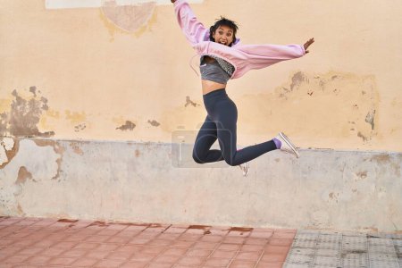 Photo for Young woman smiling confident jumping at street - Royalty Free Image