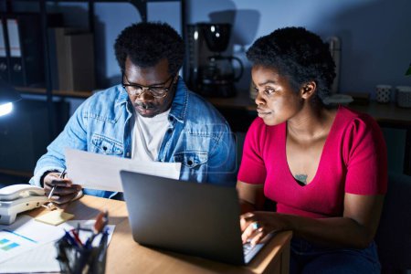 Photo for African american man and woman business workers using laptop working at office - Royalty Free Image