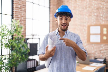 Photo for Arab man with beard wearing architect hardhat at construction office smiling happy pointing with hand and finger - Royalty Free Image