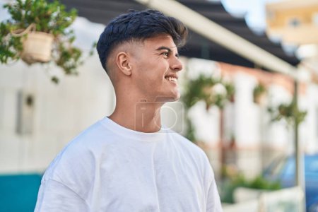 Photo for Young hispanic man smiling confident looking to the side at street - Royalty Free Image