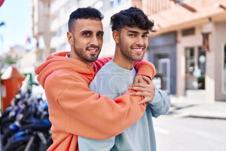 Photo for Two man couple hugging each other standing at street - Royalty Free Image