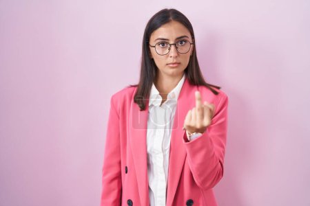 Foto de Young hispanic woman wearing business clothes and glasses showing middle finger, impolite and rude fuck off expression - Imagen libre de derechos