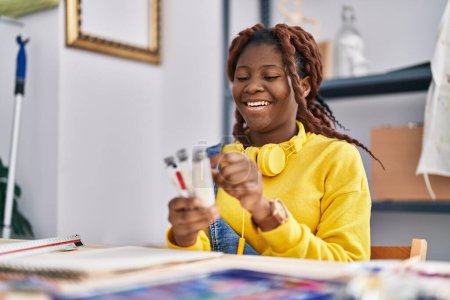Photo for African american woman artist smiling confident choosing color at art studio - Royalty Free Image