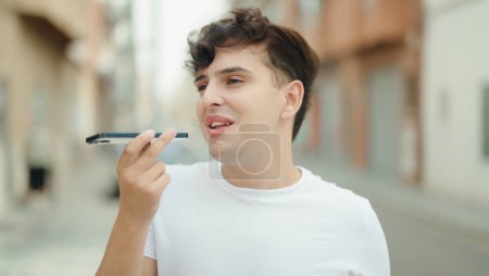 Photo for Non binary man smiling confident talking on smartphone at street - Royalty Free Image