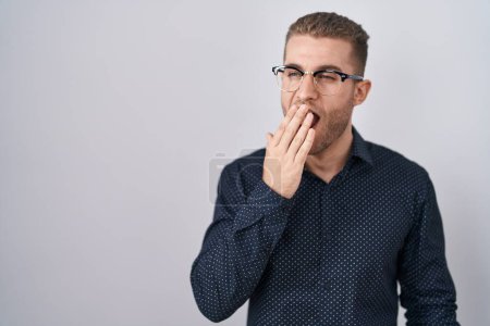 Photo for Young caucasian man standing over isolated background bored yawning tired covering mouth with hand. restless and sleepiness. - Royalty Free Image
