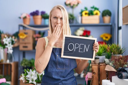 Photo for Young caucasian woman working at florist with open sign covering mouth with hand, shocked and afraid for mistake. surprised expression - Royalty Free Image