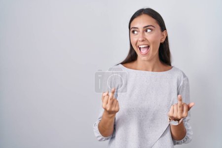 Photo for Young hispanic woman standing over white background showing middle finger doing fuck you bad expression, provocation and rude attitude. screaming excited - Royalty Free Image