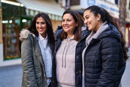 Photo for Three woman mother and daughters standing together at street - Royalty Free Image