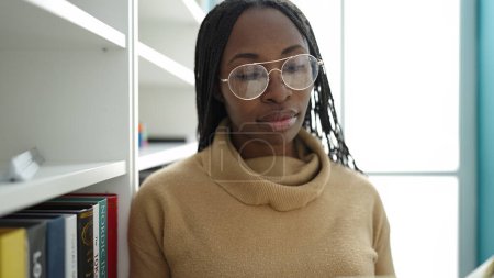 Photo for African woman reading a book at library university - Royalty Free Image
