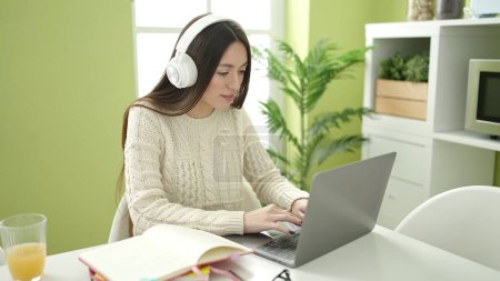 Photo for Young beautiful hispanic woman student using laptop studying at home - Royalty Free Image