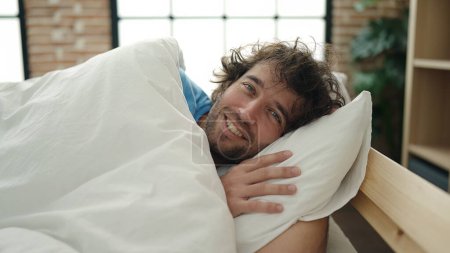 Photo for Young hispanic man smiling confident lying on bed at bedroom - Royalty Free Image