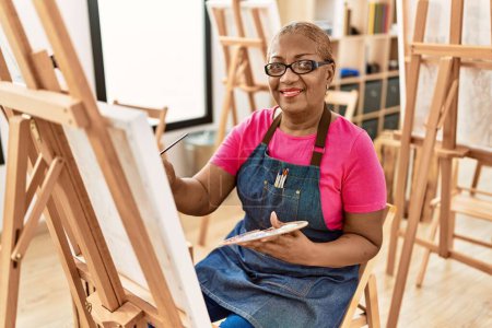 Photo for Senior african american woman smiling confident drawing at art studio - Royalty Free Image