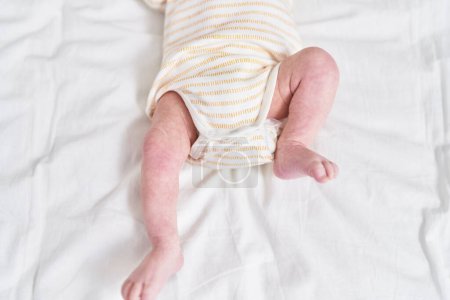 Foto de Adorable caucasian baby lying on bed at bedroom - Imagen libre de derechos