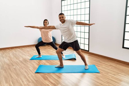 Photo for Latin man and woman couple smiling confident training yoga at sport center - Royalty Free Image