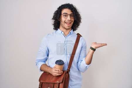 Téléchargez les photos : Hispanic man with curly hair drinking a cup of take away coffee pointing aside with hands open palms showing copy space, presenting advertisement smiling excited happy - en image libre de droit