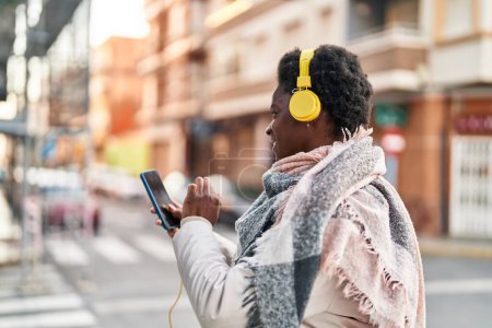 Photo for African american woman smiling confident listening to music at street - Royalty Free Image