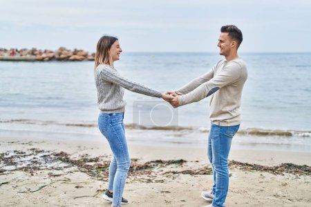 Photo for Man and woman couple smiling confident dancing at seaside - Royalty Free Image