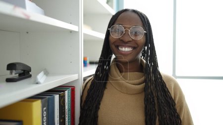Photo for African woman smiling confident at library university - Royalty Free Image