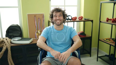 Photo for Young hispanic man sportsman smiling confident sitting on wheelchair at rehab clinic - Royalty Free Image