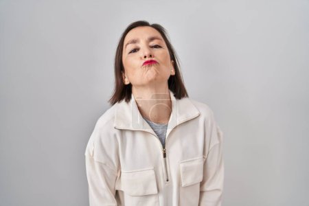 Photo for Middle age hispanic woman standing over isolated background looking at the camera blowing a kiss on air being lovely and sexy. love expression. - Royalty Free Image