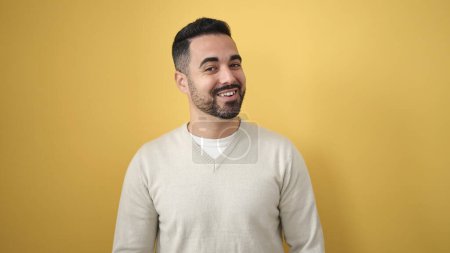 Photo for Young hispanic man smiling confident standing over isolated yellow background - Royalty Free Image